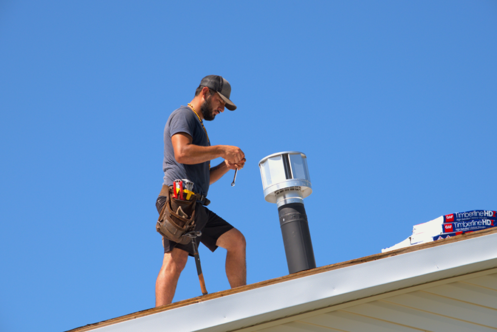 exterior specialist fixing pipe boot on residential roof