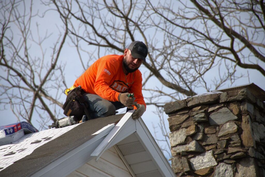 Pro Exteriors team member on a roof