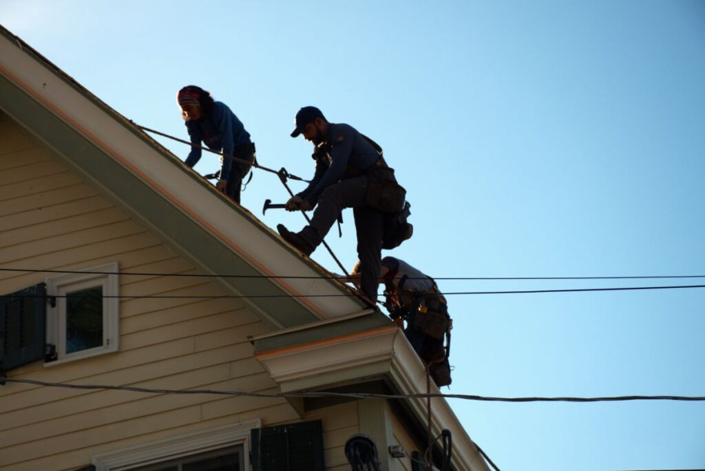 Pro Exteriors team working on a roof