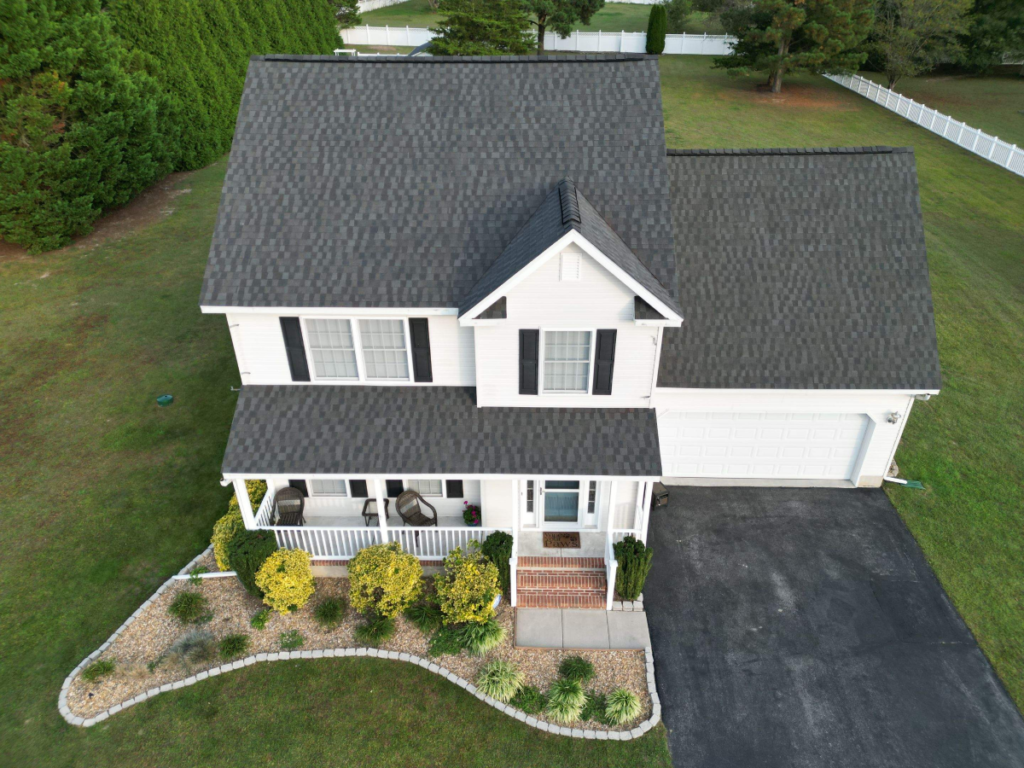 A newly replaced roof on a white house