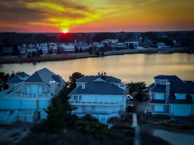 Pro Exteriors roofing crew installs Brava Roof tiles on Rehoboth Beach Delaware home at sunset
