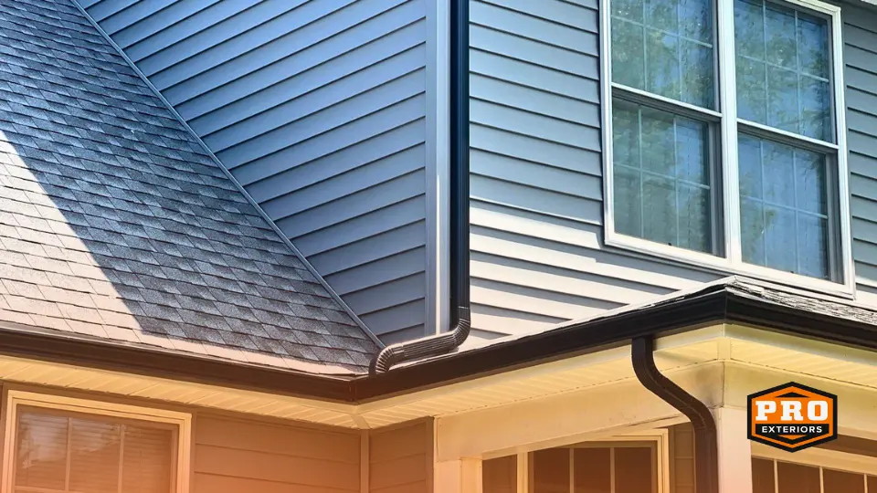 closeup image of black aluminum seamless gutters and downspouts installed by the professionals at pro exteriors in rehoboth beach delaware